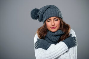 woman-with-hat-scarf-inside-home-shivering