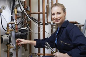 woman-technician-working-on-boiler